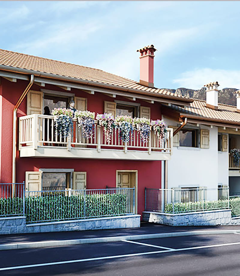 Render della Residenza Sabrina a Brentonico: facciata rossa con balcone in legno fiorito