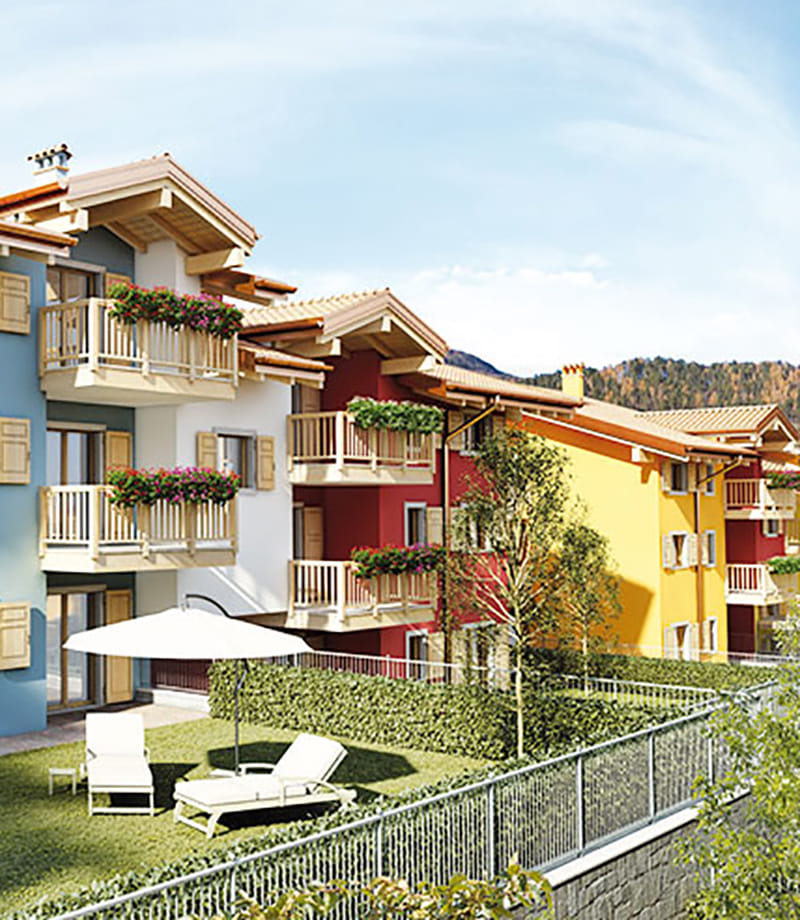 Render della Residenza Sabrina a Brentonico: edifici colorati con balconi, giardino e montagne